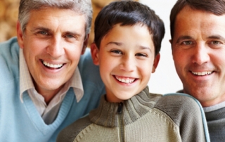 Closeup of three generational male family smiling